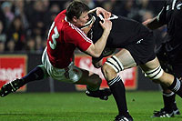 British and Irish Lions player Brian O'Driscoll is hammered in the tackle by Jono Gibbes