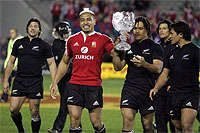All Black flanker Jerry Collins holds the trophy 