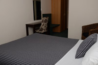 A comfortable bedroom at Greenlane Manor Motel