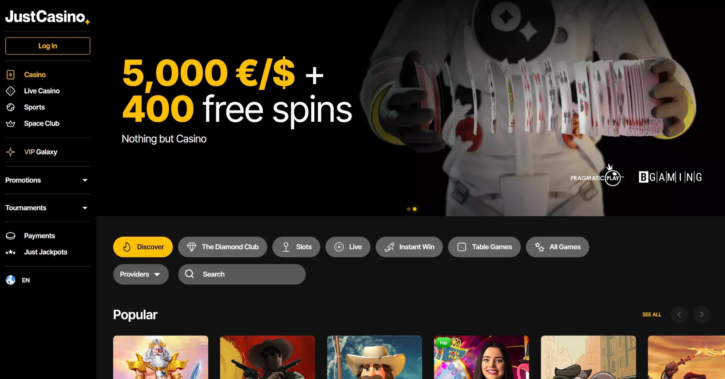 JustCasino frontpage showing welcome bonus offer, selection of online pokies and site navigation